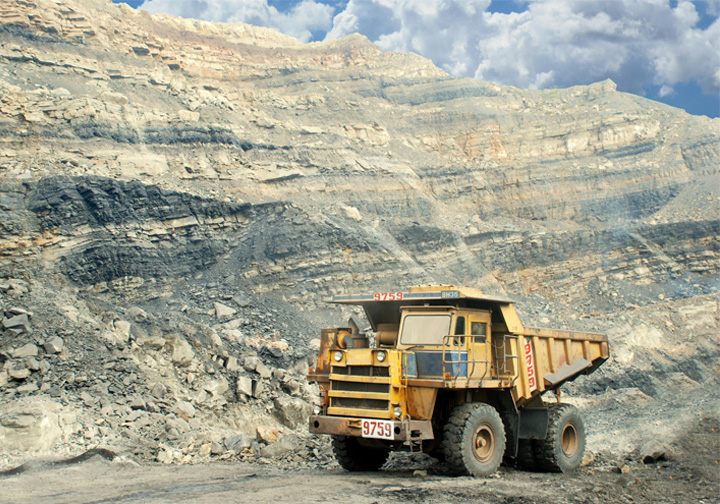 A cargo carrying truck in front of a rocky landscape