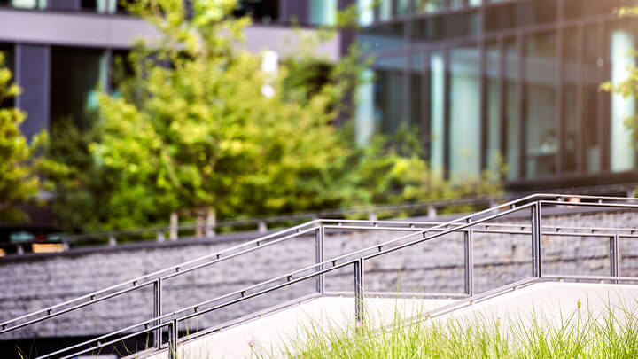 Outside of an office building surrounded by green space