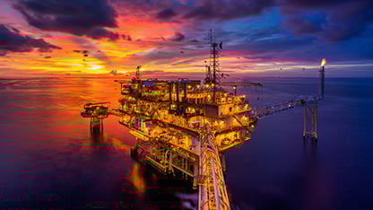  Oil platform at sea, lit up, at dusk