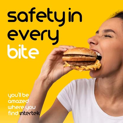 A woman taking a bite from a hamburger